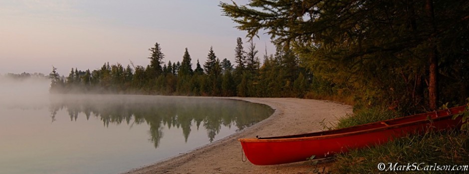Canoe on shore of foggy lake, ©markscarlson.com