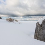 Stump on snowy Lake Michigan shoreline ©Shane Wyatt | Great Lakes Photo Tourse